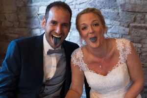 Paar mit herausgestreckten, blaugefärbten Zungen